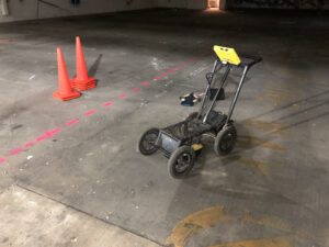 Ground-penetrating radar equipment in use on a concrete surface, demonstrating its role in 'Dig Alert and GPR' for safe underground excavations.