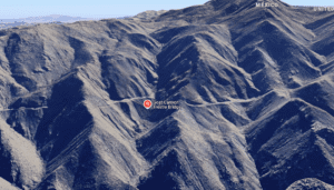 Aerial view of the mountainous landscape around Goat Canyon Trestle, showing the bridge's location amid steep, rocky terrain, highlighting its engineering significance.