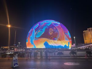 Colorful illuminated display of The Sphere Las Vegas at night, showcasing its innovative design and technology.